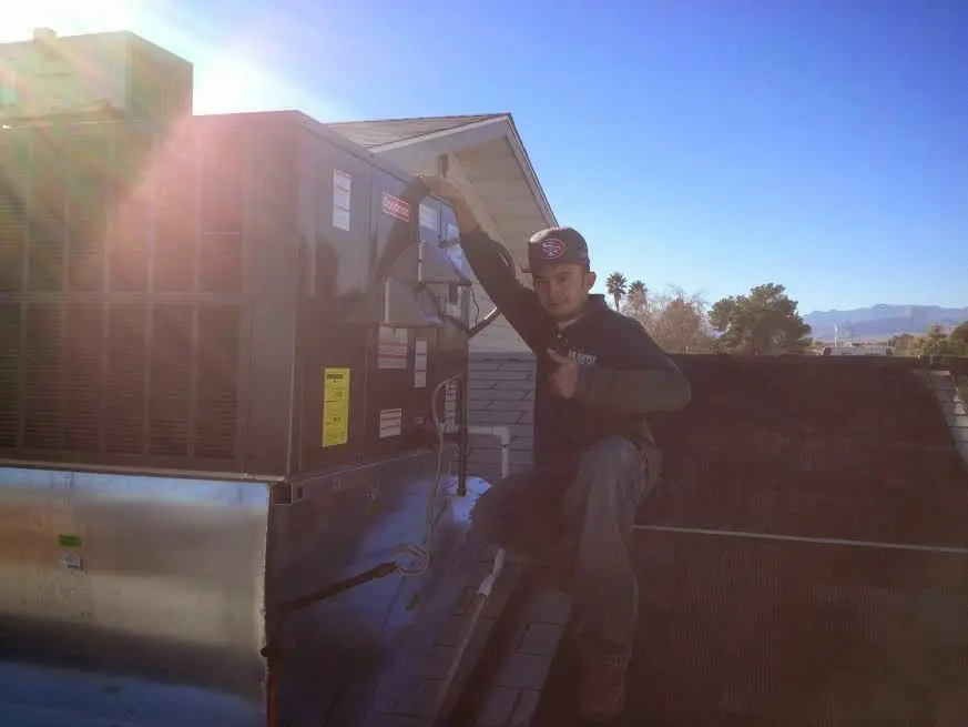 HVAC technician performing HVAC Inspection on a rooftop unit in Spanish Springs